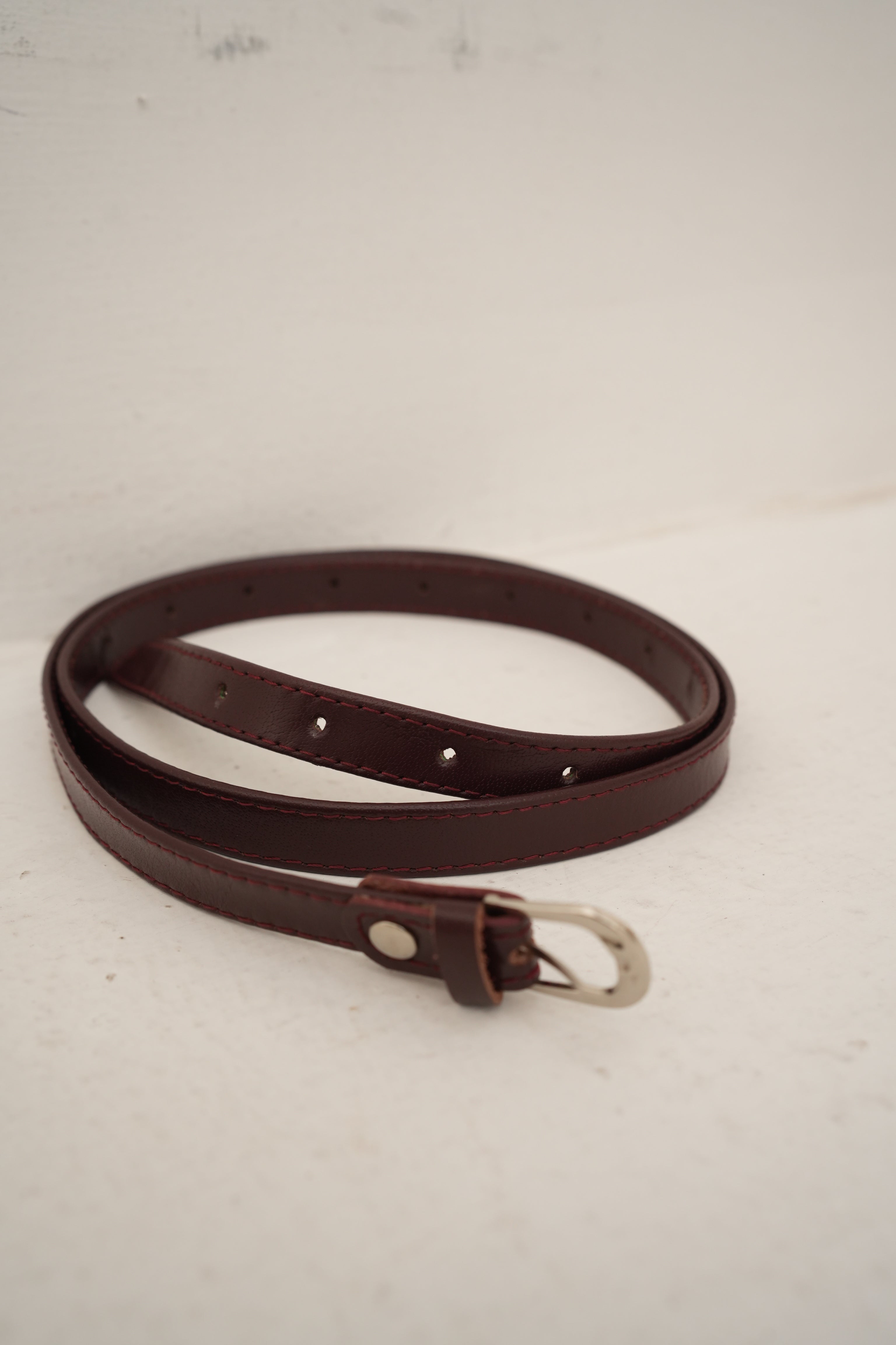 sleek dark brown belt with silver buckle at Apricocia